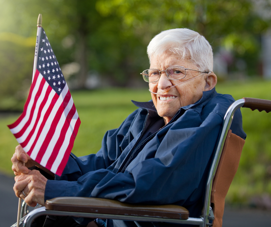 Veteran in chair with flag